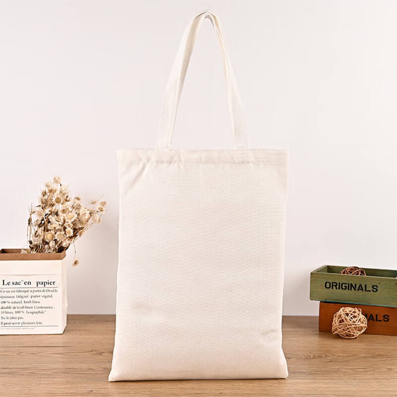 Natural canvas tote bag with blue custom logo on the front