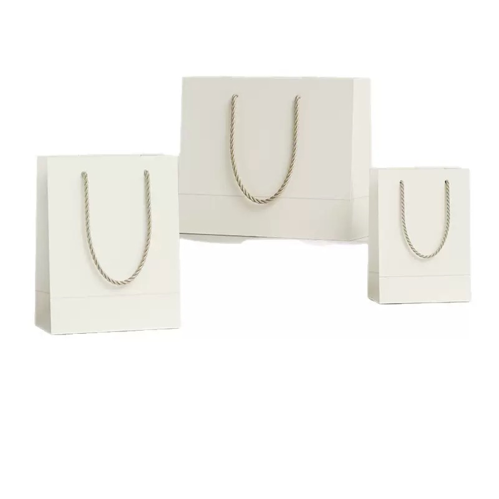 White paper shopping bags with rope handles in multiple sizes