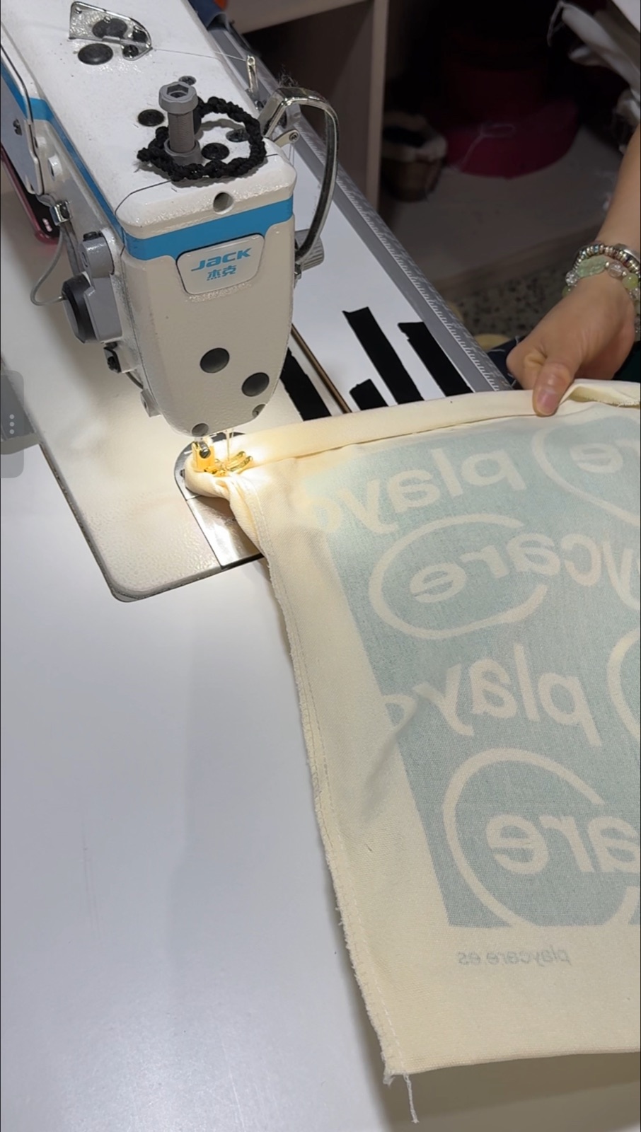 Sewing a printed cotton tote bag during production