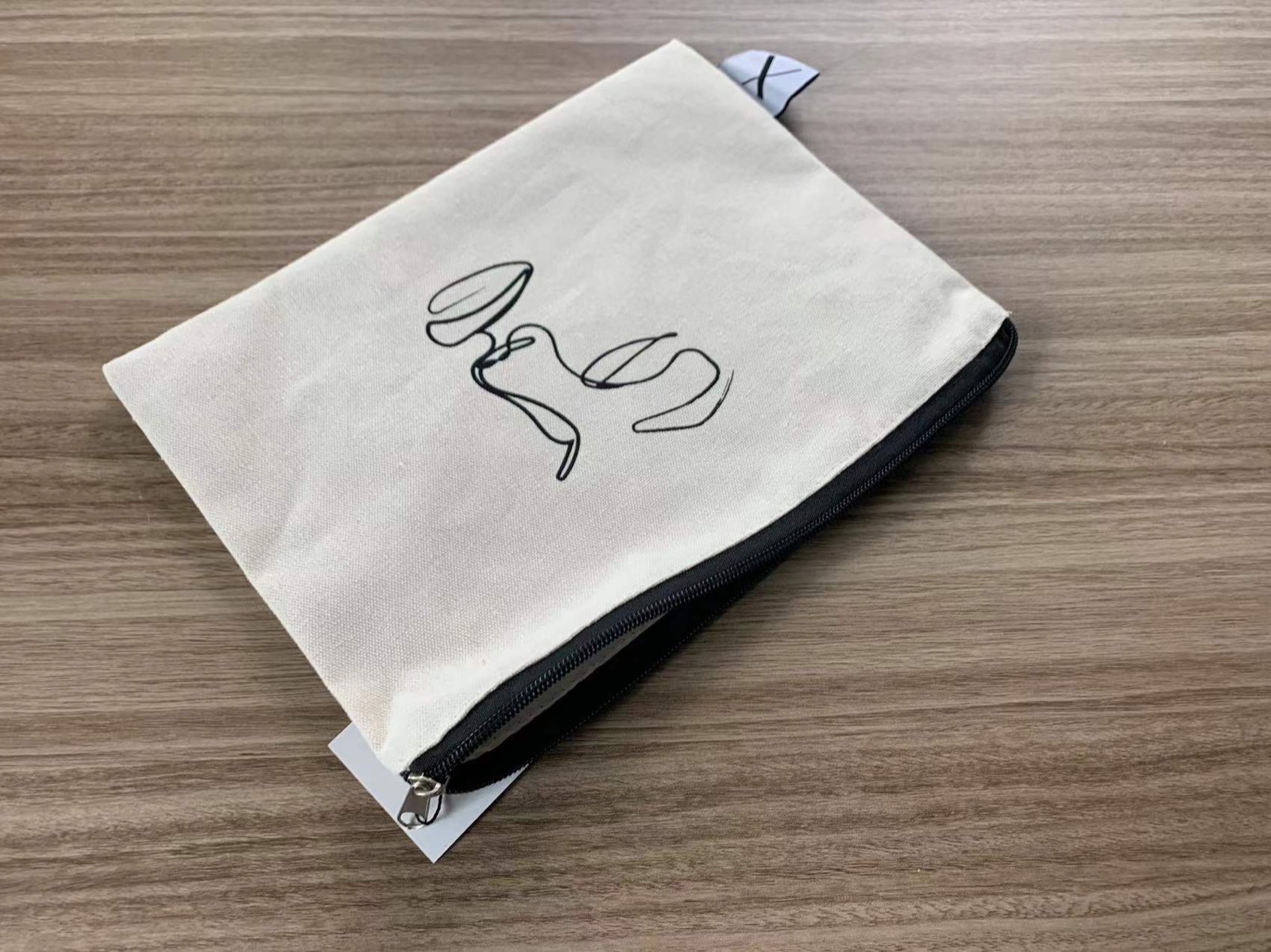 Small canvas zipper pouch with simple black line artwork